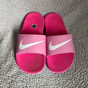Hot pink Nike slides. 4.5 kids, but will fit women’s size 5.5-6.